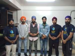 UNITED SIKHS volunteers stand with Gurpreet Singh upon release from policy custody