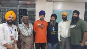 UNITED SIKHS Ground Coordinator Mohinderjit Singh (c) stands with Anil Singh (l), Bittu Maci (r) and their families upon bail